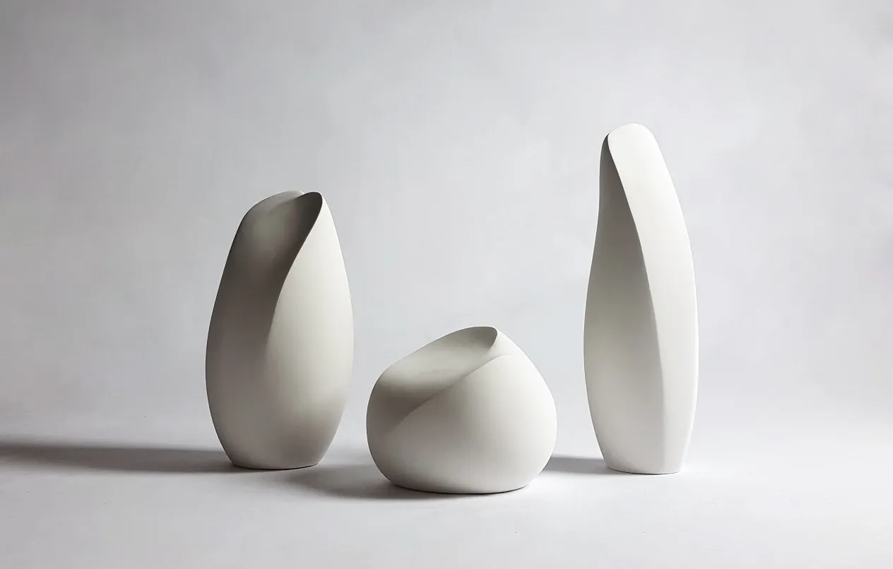 Three white ceramic form studies