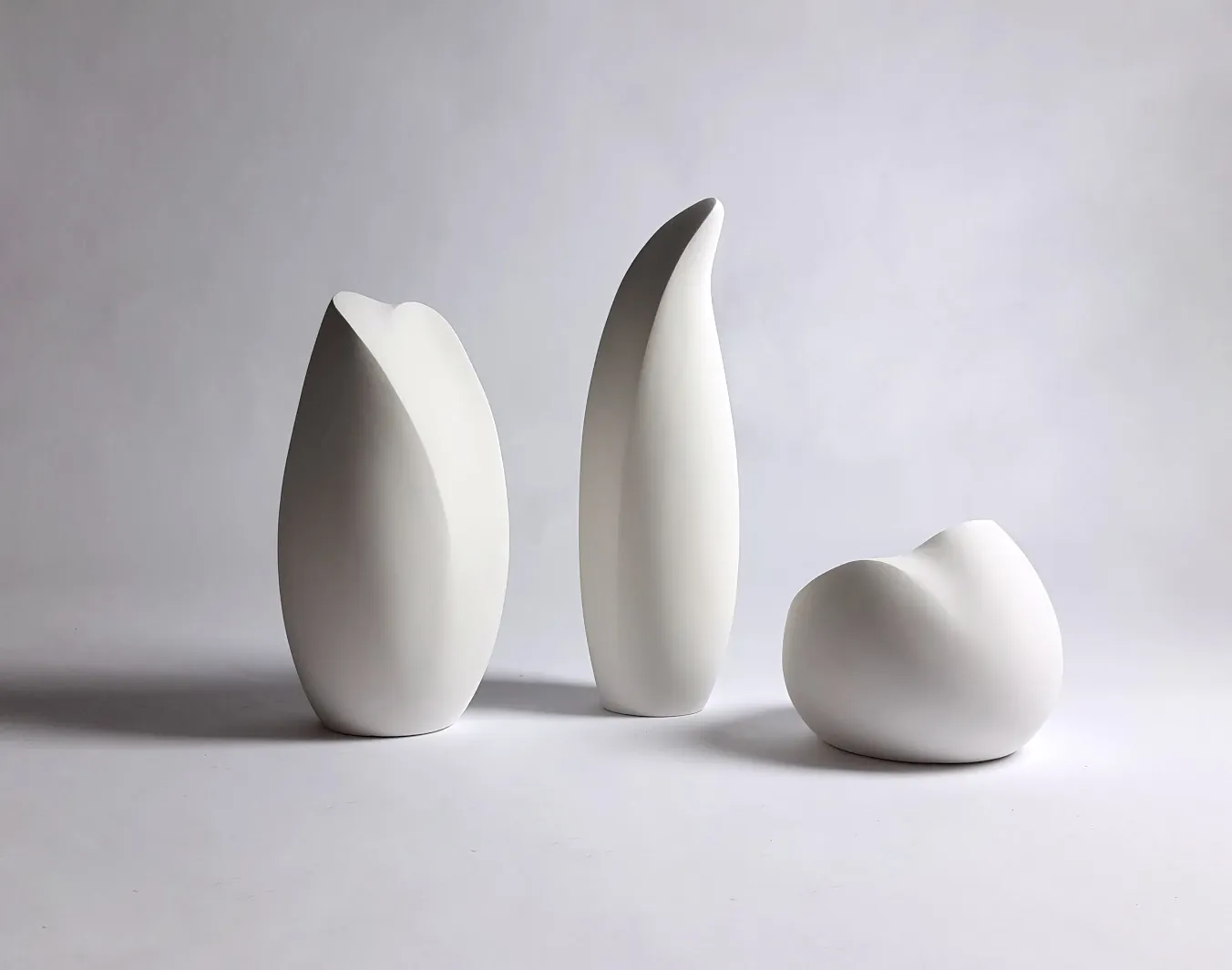 Three white ceramic form studies, second angle