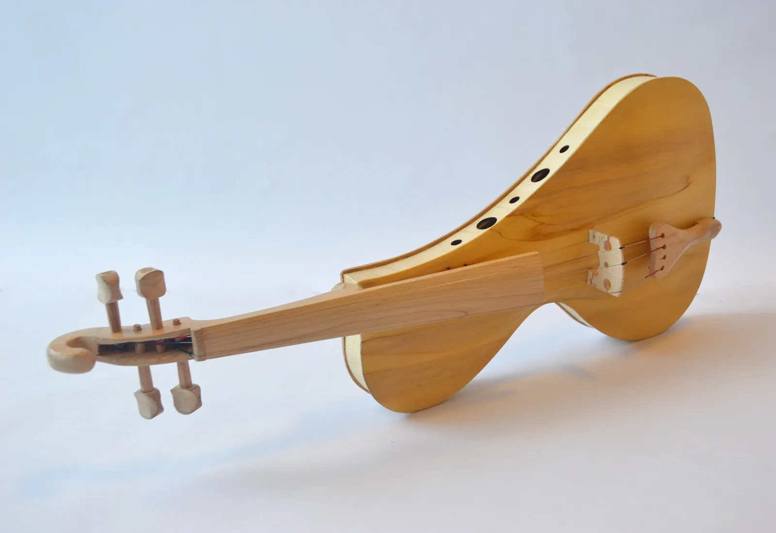 Modern violin carved in pale wood