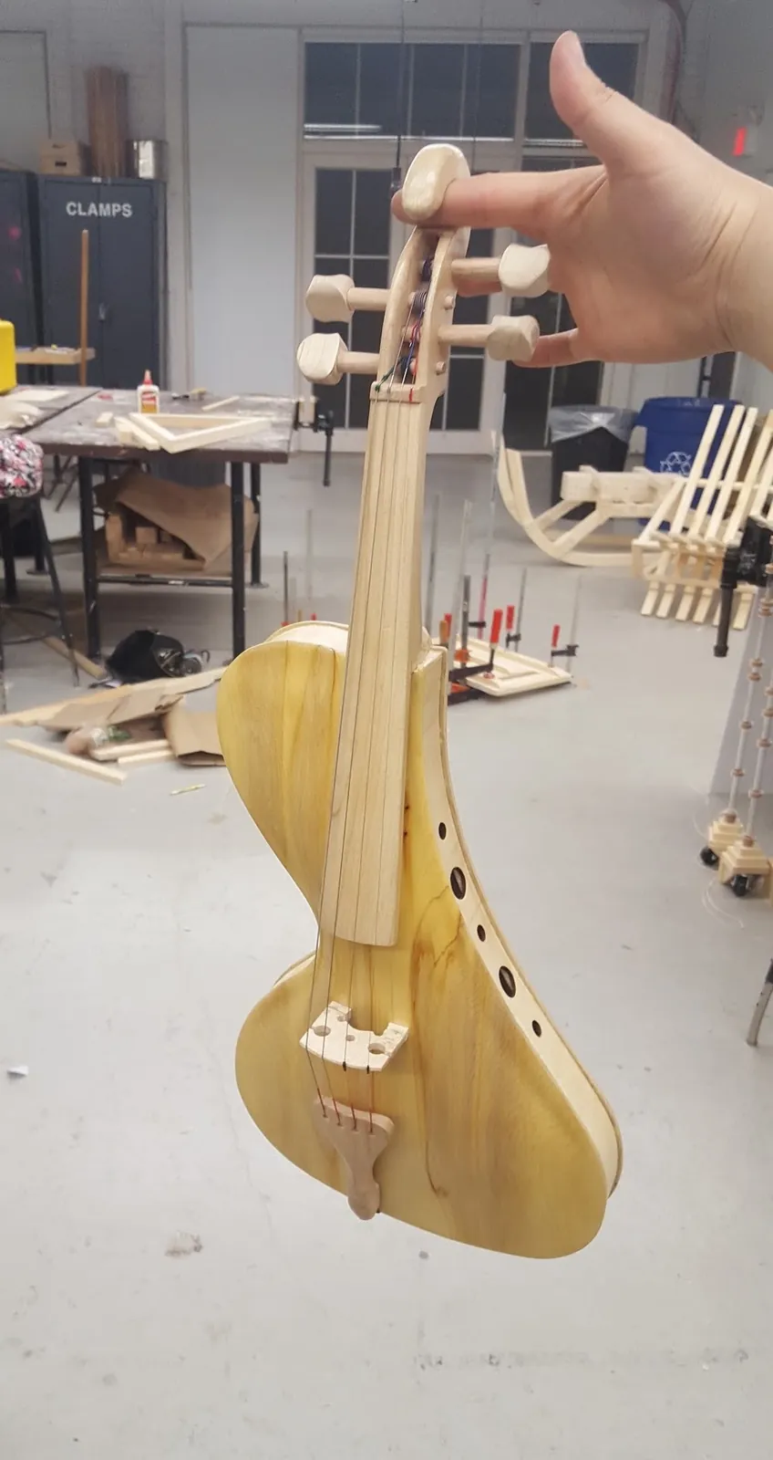 Holding the modern violin in the workshop