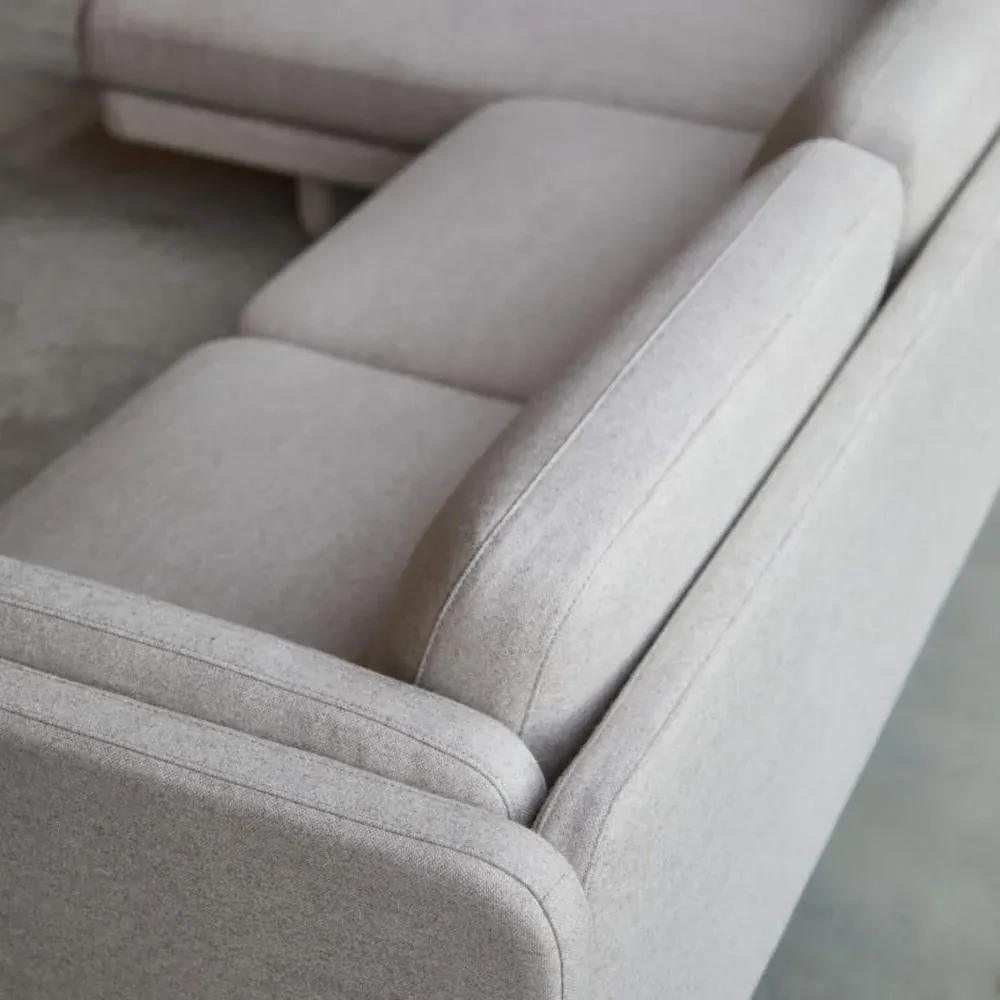 Close-up of the sofa cushions from above: the seams and the soft, pillowed edges of the seat and back