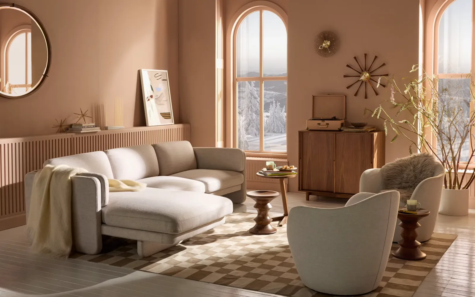 The sectional in oatmeal upholstery in a terracotta living room with arched windows