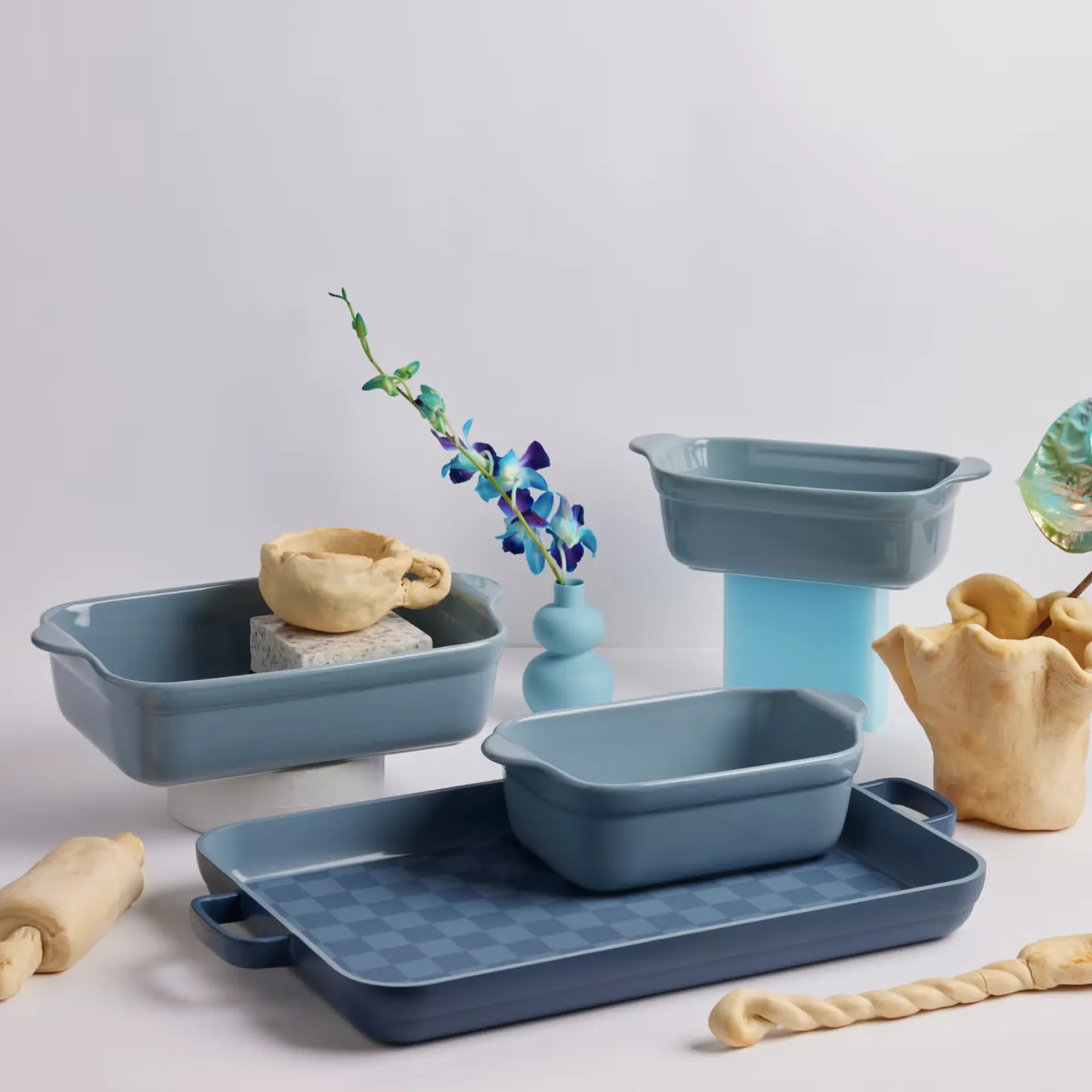 Blue bakeware set: loaf pan, baking dishes, and sheet pan with pastries