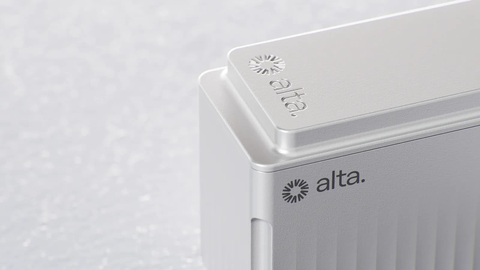 Close-up of the battery corner: the vertical ribs fading out toward the lid and the debossed alta logo
