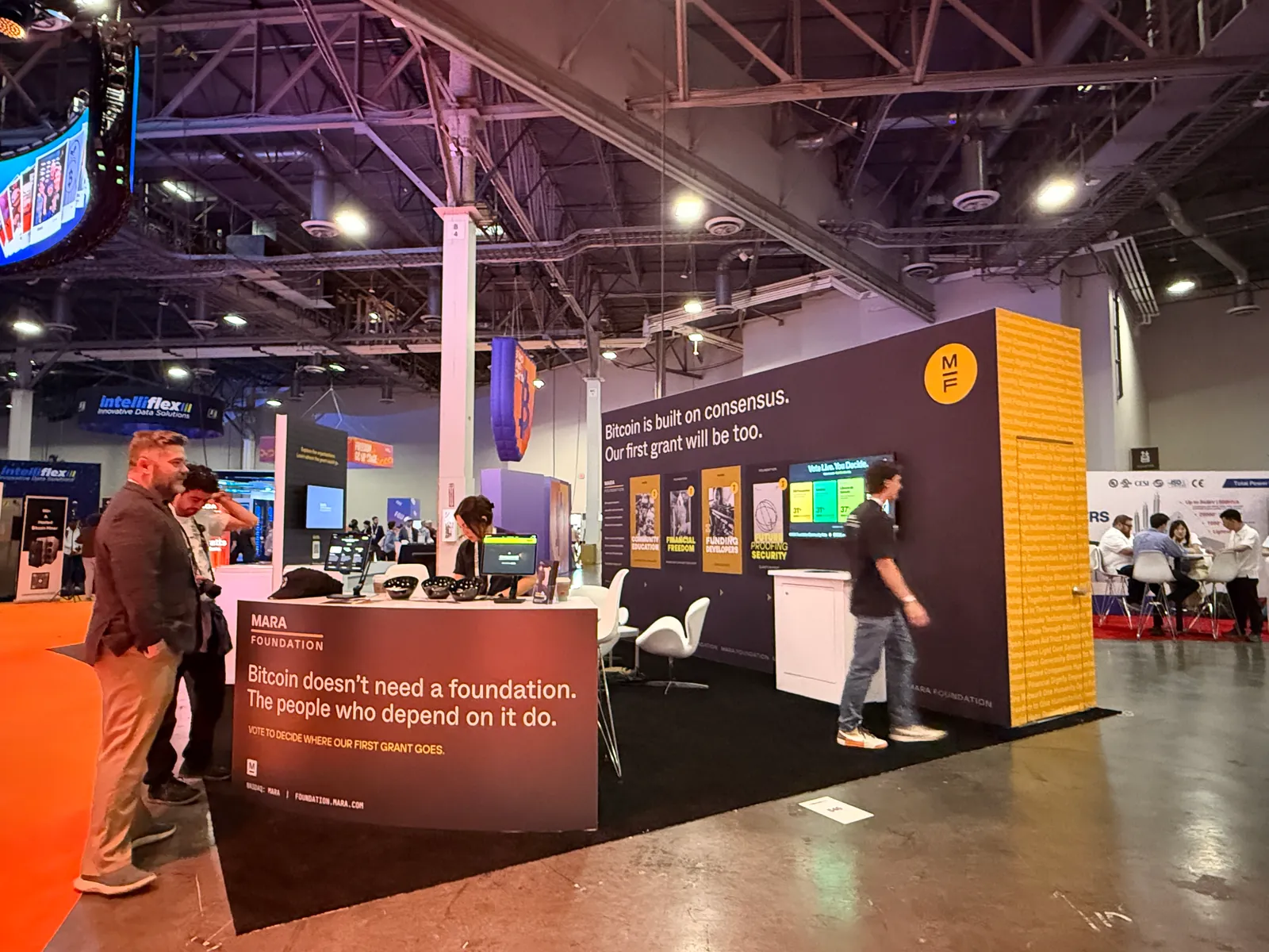 Booth counter reading Bitcoin does not need a foundation, the people who depend on it do, with visitors